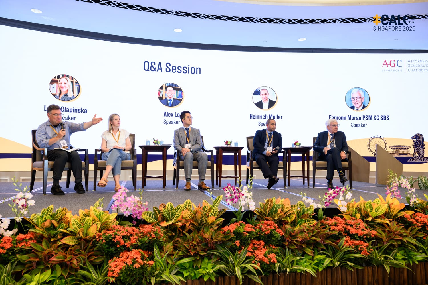 Speakers Lydia Clapinska, Alex Lo, Heinrich Muller, and Eamonn Moran PSM KC SBS during a Q&A session at the Conference, seated on stage at The Fullerton Hotel Singapore.